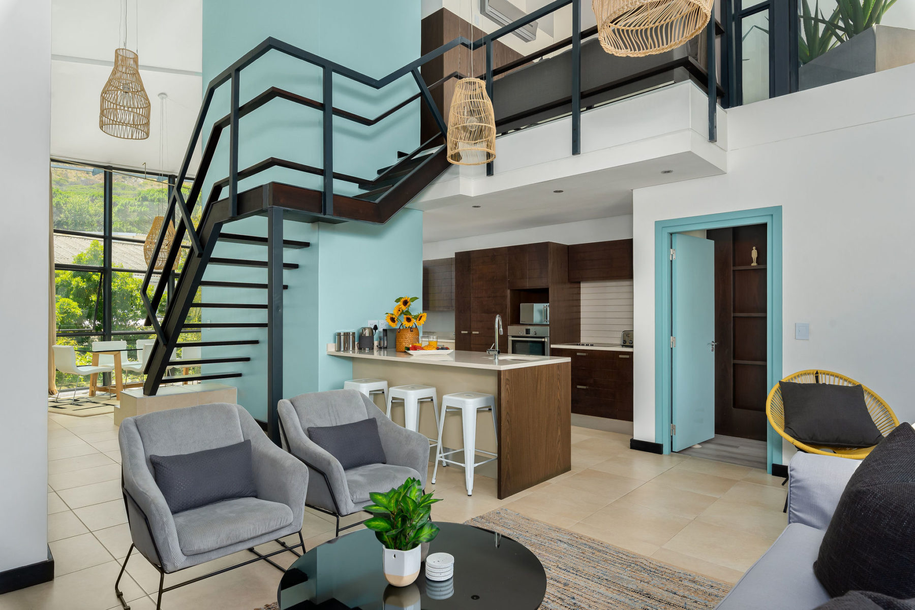 Open plan living with stairs leading to bedroom 1